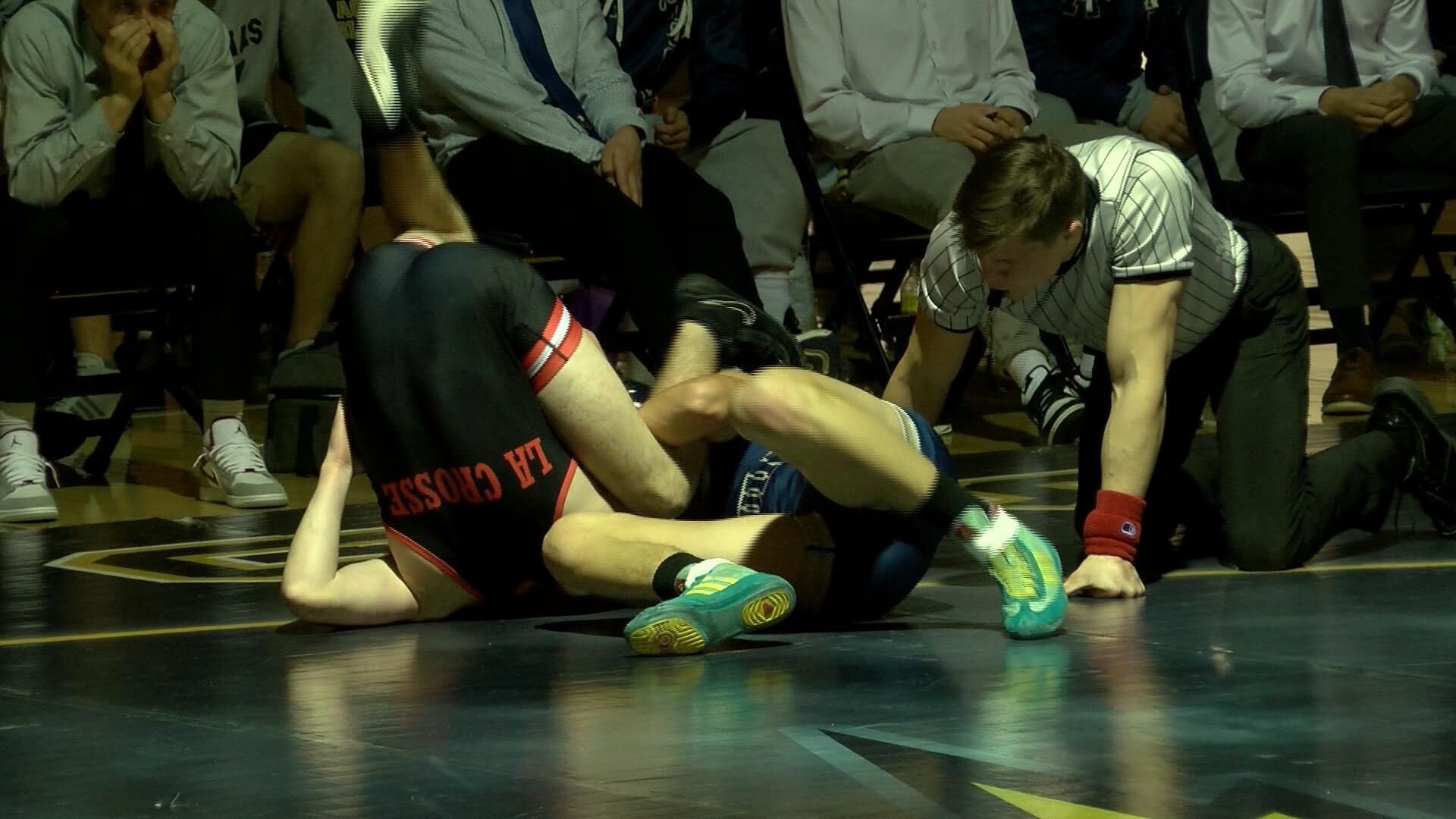 Aquinas' Jesse Penchi gets a pin